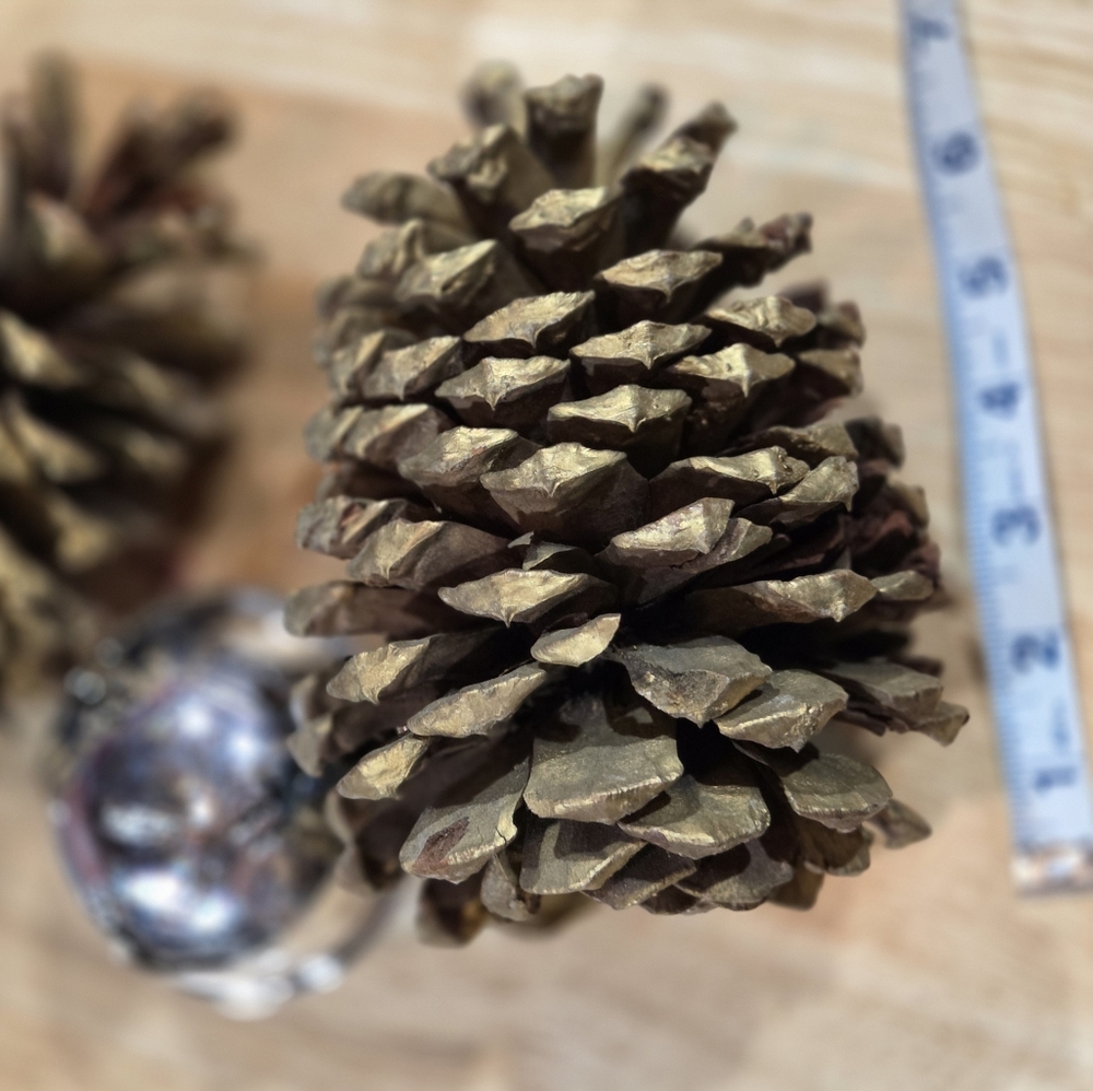 Silver Bell Ornament with Reindeer Motif and Large Gold Pine Cones